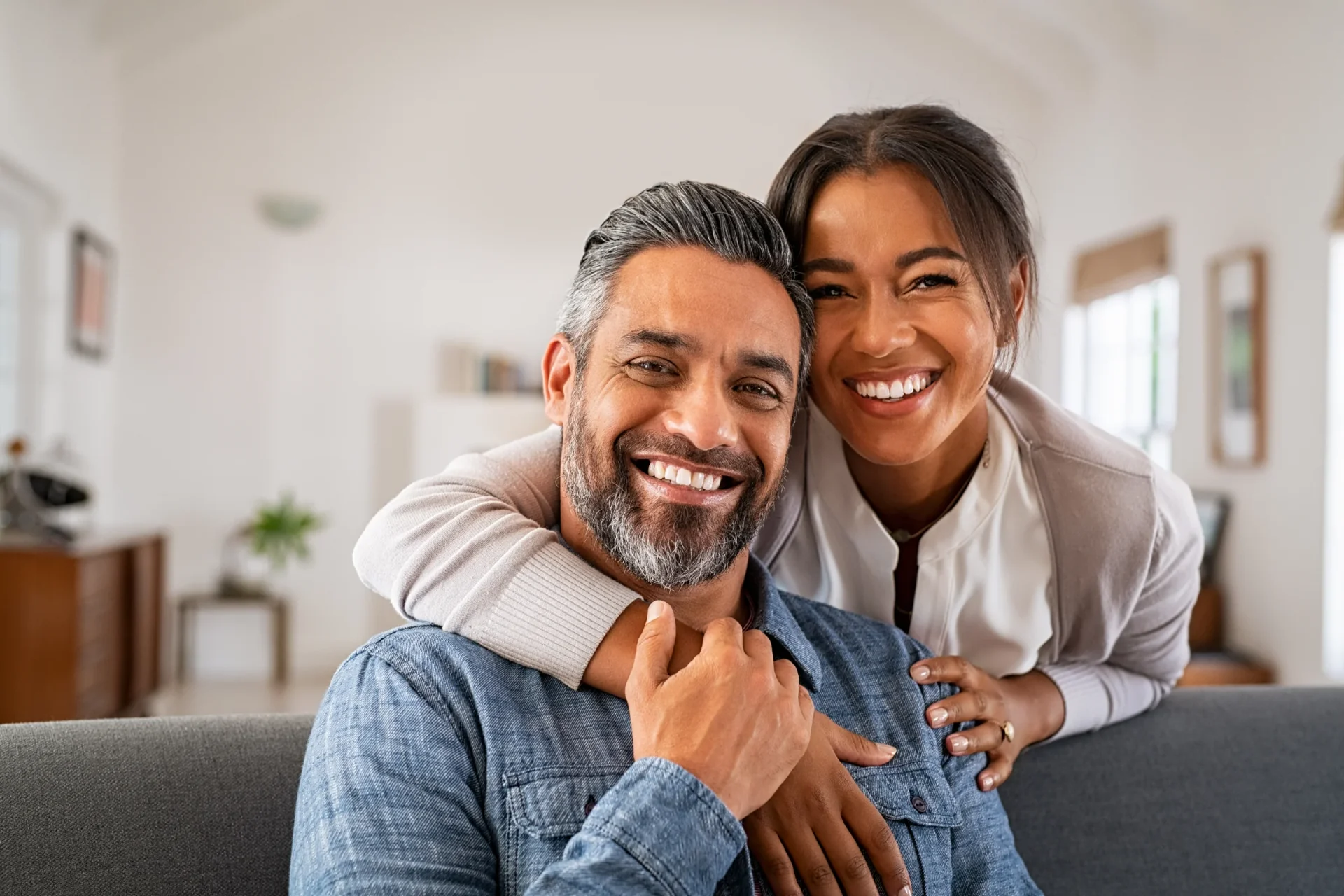 A smiling couple relaxing together at home
