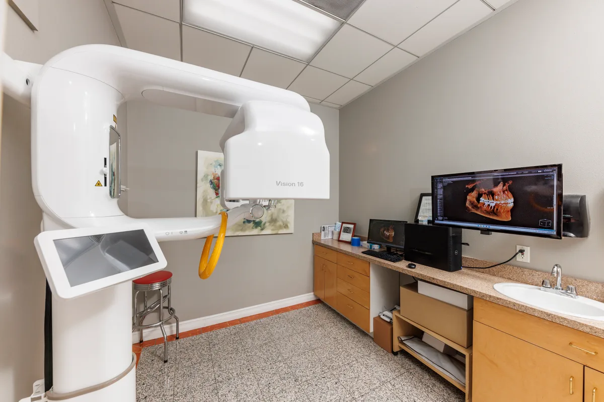 Cone-beam dental imaging equipment and computer displays in a treatment room